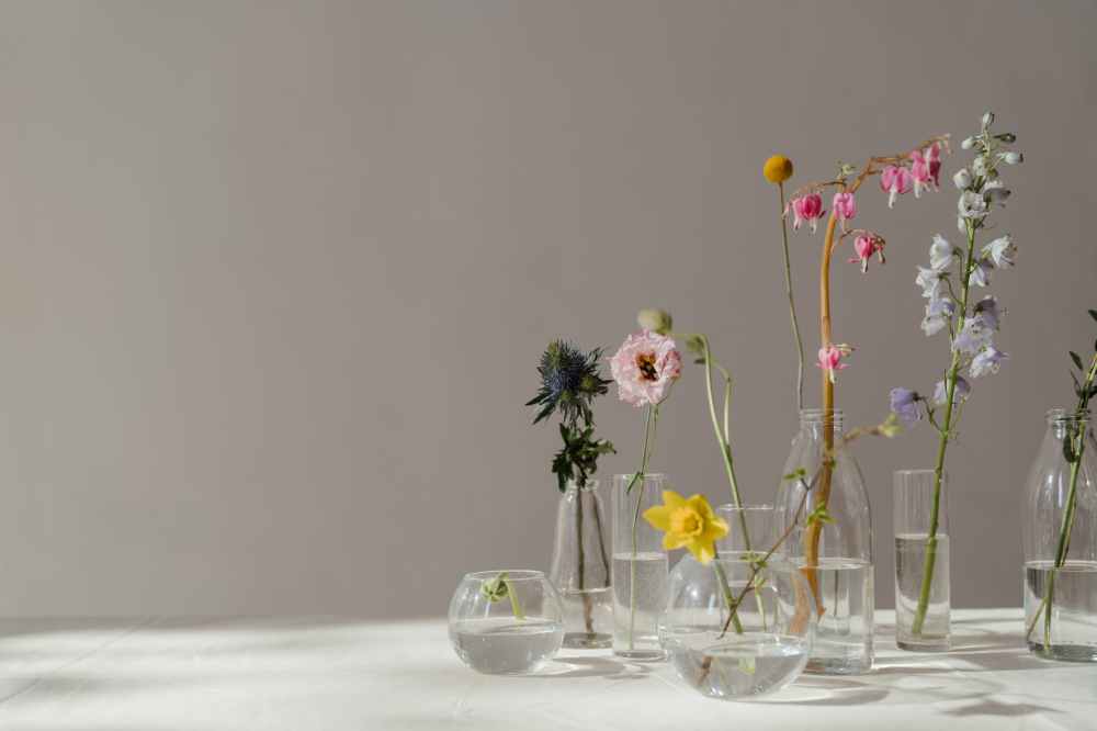 photo of flowers in glass vase with water